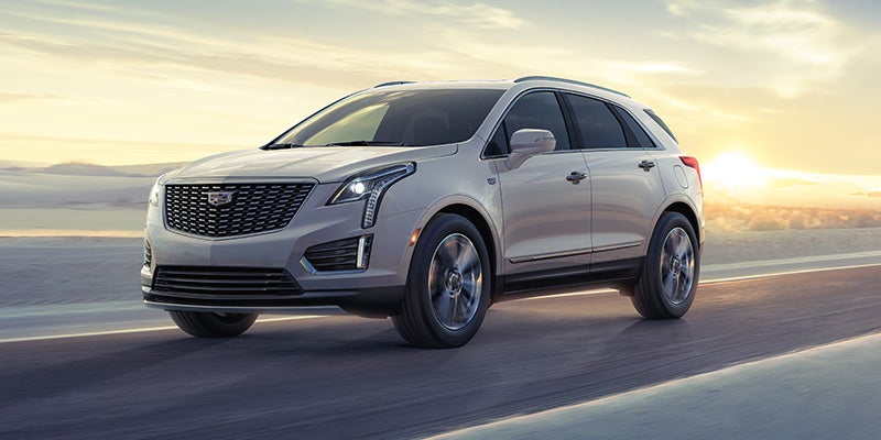 A Cadillac XT5 driving smoothly on the road.